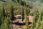 Nestled amidst a lush forest, this charming home offers a serene retreat with its natural surroundings.