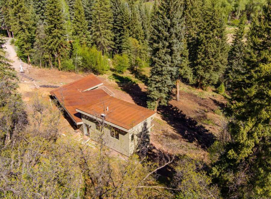 Nestled amidst a lush forest, this property offers a serene retreat with its unique architecture and natural surroundings.