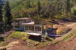 Nestled amidst lush greenery, this contemporary home offers a serene retreat with stunning natural views.
