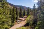 Nestled amidst a serene forest landscape, this unique home offers a tranquil retreat with stunning mountain views.