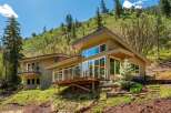 Nestled on a lush hillside, this modern home offers stunning natural views and a seamless indoor-outdoor living experience.