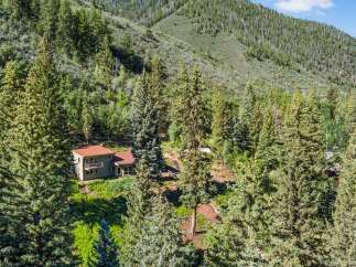 Nestled amidst a lush forest, this secluded home offers a tranquil retreat with stunning natural surroundings.