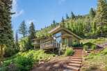 Nestled amidst lush greenery and rolling hills, this modern home offers a serene retreat with stunning natural views.