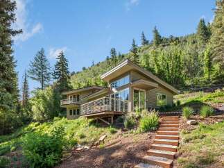 Nestled amidst lush greenery and rolling hills, this modern home offers a serene retreat with stunning natural views.