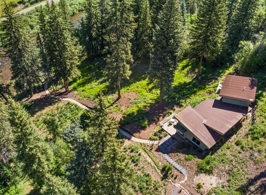 Nestled amidst a lush pine forest, this property offers a serene retreat with a charming home featuring a spacious deck perfect for enjoying the natural surroundings.