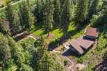 Nestled amidst a lush pine forest, this property offers a serene retreat with a charming home featuring a spacious deck perfect for enjoying the natural surroundings.