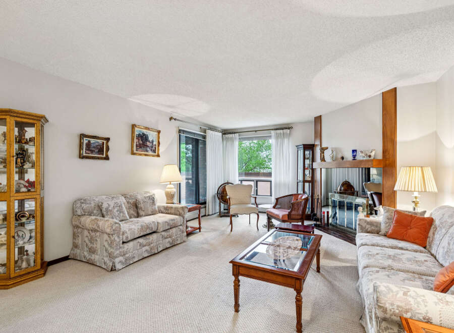 Step into this inviting living room, featuring a floral-patterned sofa and a matching loveseat perfect for relaxation.