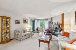 Step into this inviting living room, featuring a floral-patterned sofa and a matching loveseat perfect for relaxation.