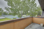 Enjoy stunning views of the tennis courts and lush greenery from this private balcony.