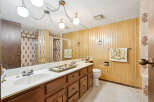 Step into this charming bathroom featuring a spacious vanity with a double sink and ample storage.
