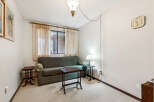 This cozy living room features a comfortable green sofa, perfect for relaxing.