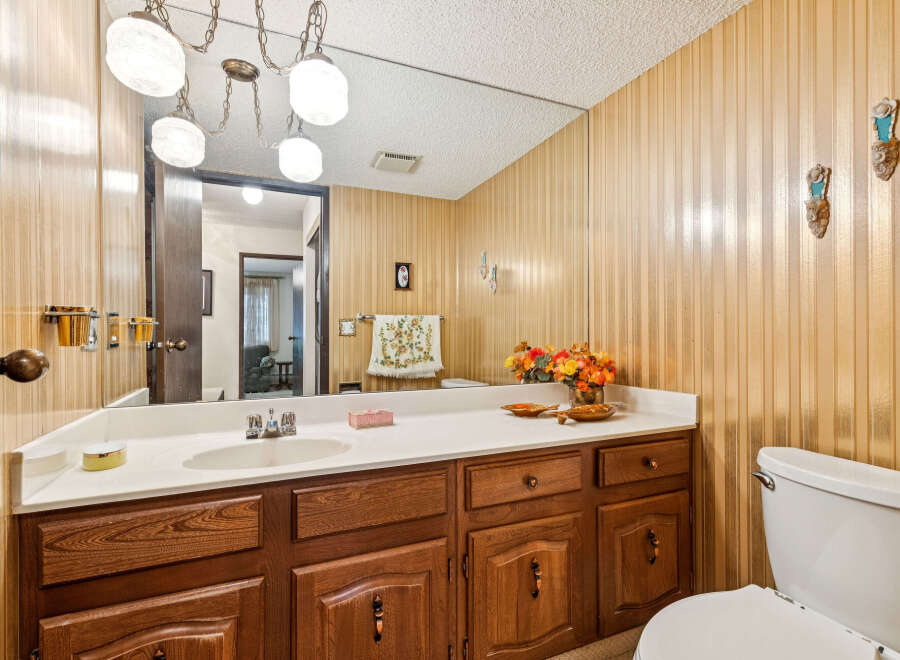 This bathroom features a spacious vanity with ample counter space and storage, perfect for organizing your essentials.