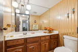 This bathroom features a spacious vanity with ample counter space and storage, perfect for organizing your essentials.