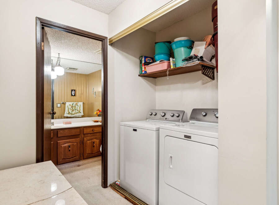 This laundry room features a stacked Maytag washer and dryer set, perfect for maximizing space.
