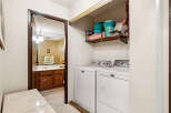 This laundry room features a stacked Maytag washer and dryer set, perfect for maximizing space.