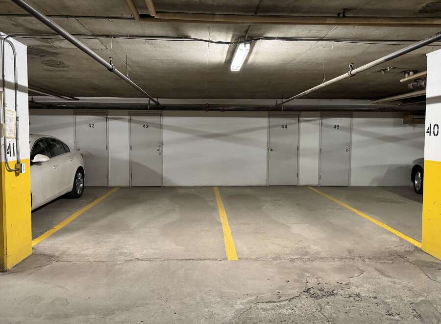 Discover secure and convenient parking in this underground garage, featuring numbered storage units for added convenience.