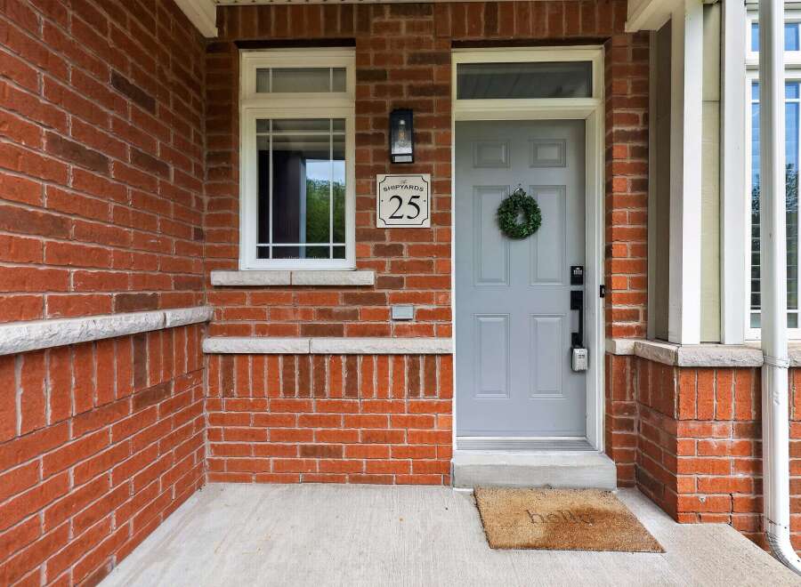 Welcome to this charming home featuring a classic red brick exterior and a welcoming front porch.