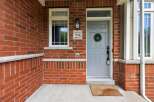 Welcome to this charming home featuring a classic red brick exterior and a welcoming front porch.