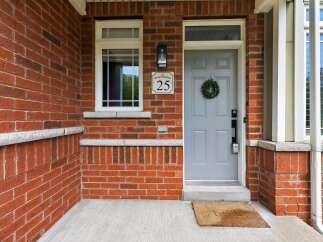 Welcome to this charming home featuring a classic red brick exterior and a welcoming front porch.