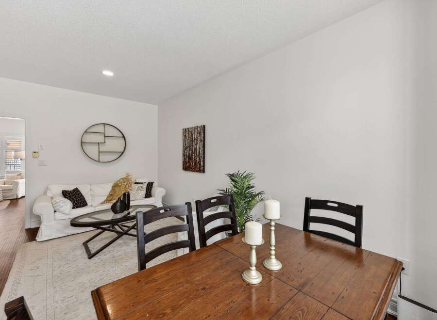 This inviting dining area features a rustic wooden table with dark wood chairs, perfect for family gatherings.