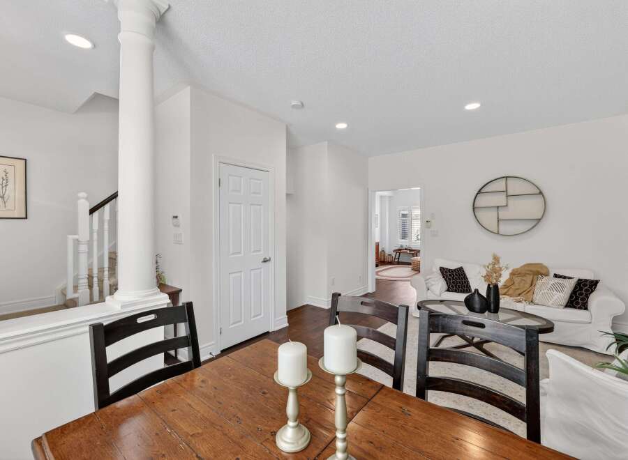 This inviting dining area features a rustic wooden table paired with dark wood chairs, perfect for family meals.