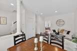 This inviting dining area features a rustic wooden table paired with dark wood chairs, perfect for family meals.