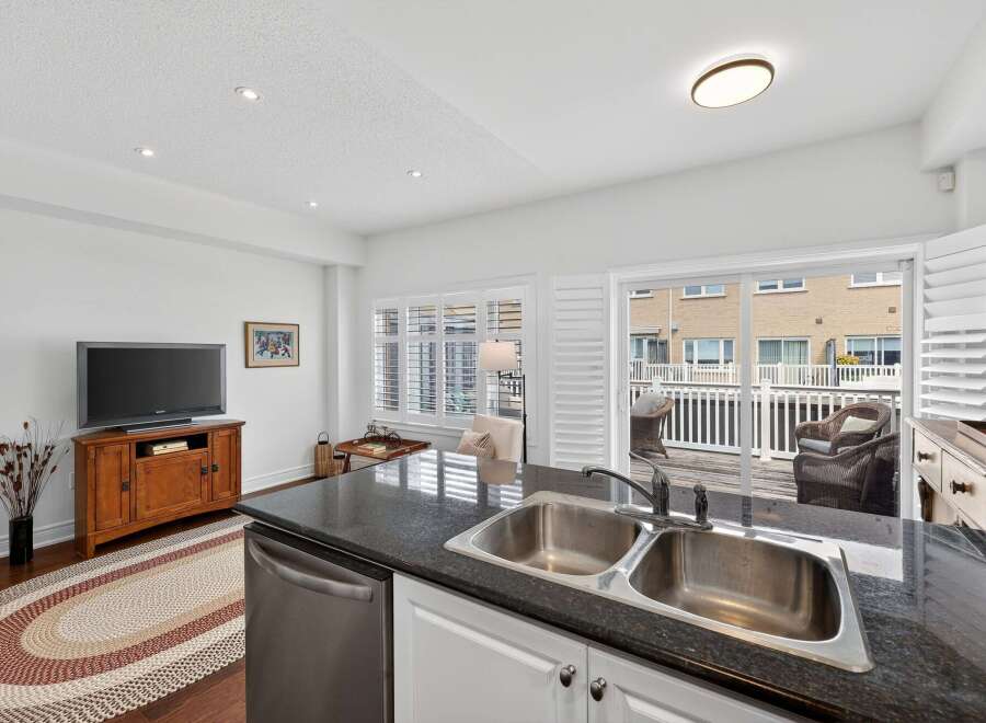 This spacious kitchen and living area offers a seamless transition to outdoor living with a large sliding glass door leading to a private deck.