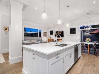 Experience modern luxury in this stunning open-concept kitchen and living area.