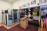 Discover a well-stocked ski shop featuring a wide array of skis and snowboards, perfect for your next mountain adventure.