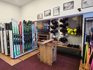 Discover a well-stocked ski shop featuring a wide array of skis and snowboards, perfect for your next mountain adventure.