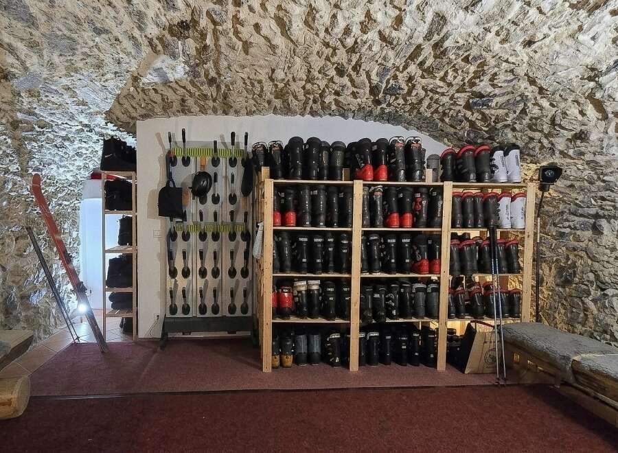 Discover the ultimate ski storage solution in this unique property, featuring a dedicated boot room with ample shelving for ski boots and equipment.
