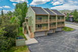 Discover this charming multi-unit property featuring a light green exterior and multiple balconies perfect for enjoying the mountain air.