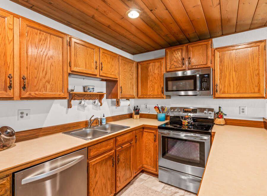 This kitchen boasts warm, honey-toned oak cabinetry offering ample storage space.