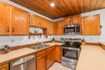 This kitchen boasts warm, honey-toned oak cabinetry offering ample storage space.