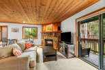 Cozy living room featuring a stone fireplace and a large sectional sofa, perfect for relaxing evenings.