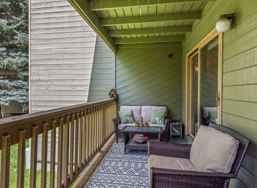 Enjoy the outdoors on this charming covered balcony, perfect for relaxing or entertaining.