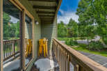 Enjoy your morning coffee or evening drink on this charming balcony, complete with a small table and two bright yellow stools.