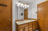 This bathroom features a spacious double vanity with a wooden cabinet base and a light-colored countertop.