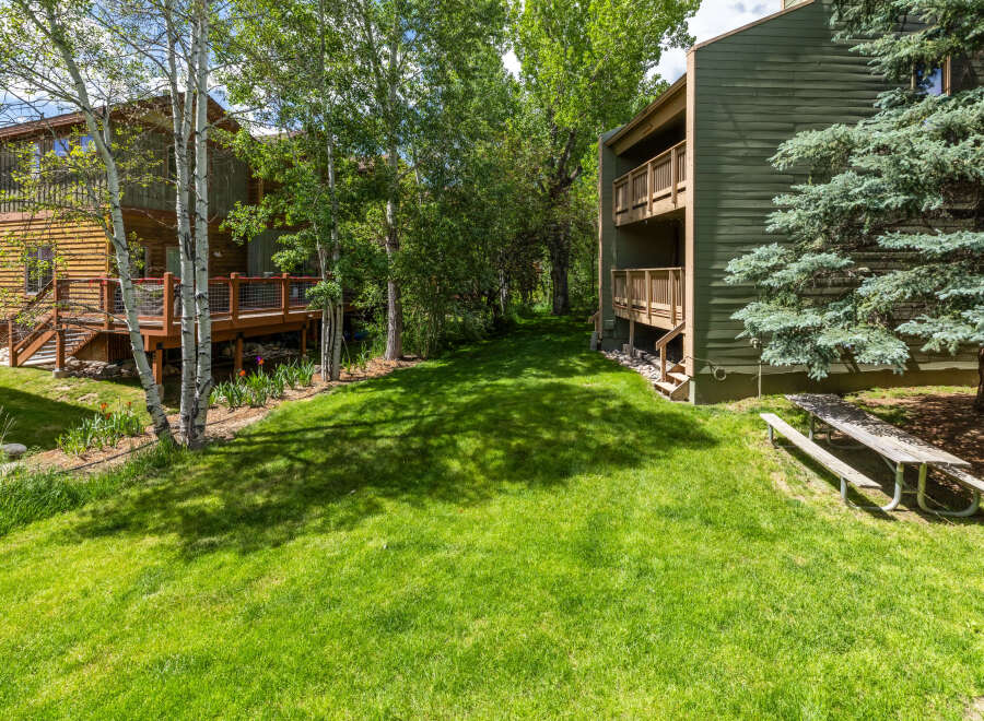 Enjoy the serene mountain setting with this charming property, featuring a spacious wooden deck perfect for outdoor relaxation and entertaining.