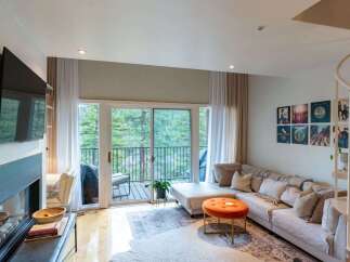 Experience modern living in this stylish living room featuring a large sectional sofa perfect for relaxation and entertaining.