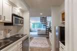 Discover this charming studio apartment featuring a compact yet functional kitchen with stainless steel appliances and ample cabinet space.