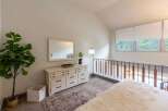 This charming bedroom features a spacious white dresser with a large mirror, perfect for storing your belongings and getting ready in style.