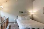 Discover this charming bedroom featuring a cozy bed adorned with plush white linens and a luxurious faux fur throw.