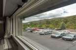 Experience the tranquility of mountain living with this property offering stunning views of a lush, forested hillside.