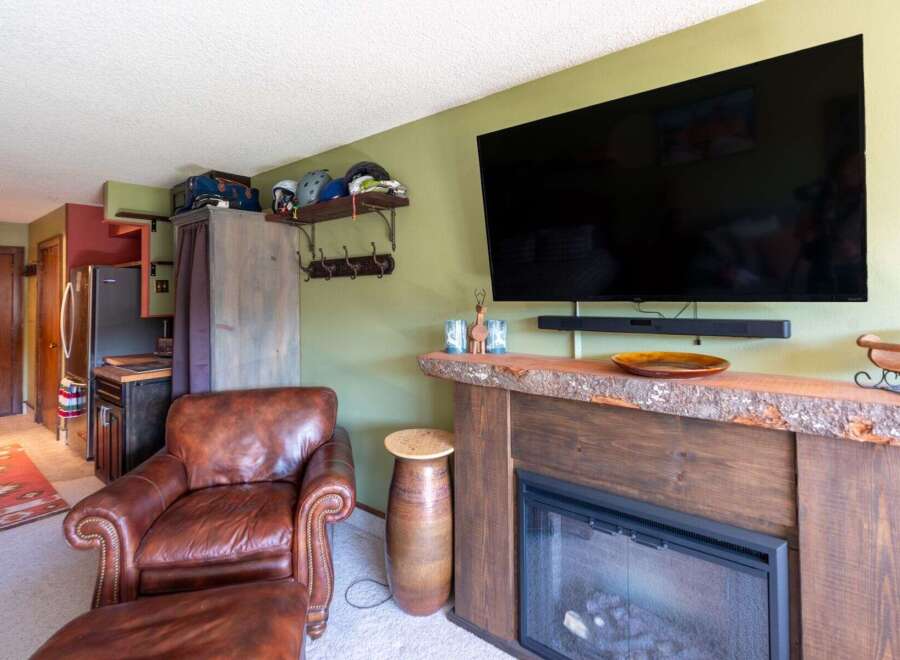 Cozy living room featuring a plush leather armchair and ottoman, perfect for relaxing after a day of outdoor adventures.