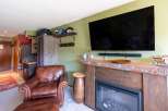 Cozy living room featuring a plush leather armchair and ottoman, perfect for relaxing after a day of outdoor adventures.