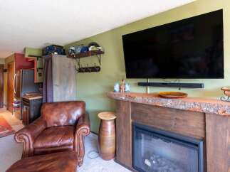Cozy living room featuring a plush leather armchair and ottoman, perfect for relaxing after a day of outdoor adventures.