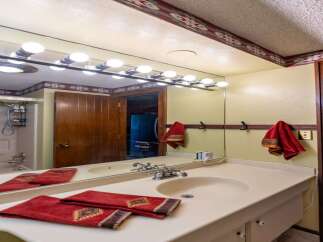 Step into this charming bathroom featuring a spacious vanity with a double sink and ample counter space.