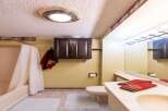 This bathroom features a clean and functional design with a bathtub and shower combination, complemented by a dark wood cabinet for storage.
