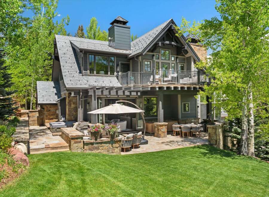 Experience luxury mountain living with this stunning property featuring a spacious outdoor patio and entertainment area, perfect for enjoying the serene surroundings.